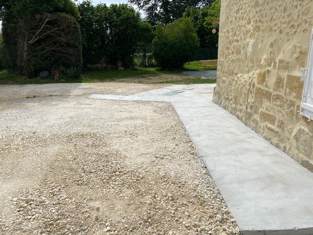 Photo d'un cheminement en béton le long d'une habitation réalisé par Duflos Aménagements